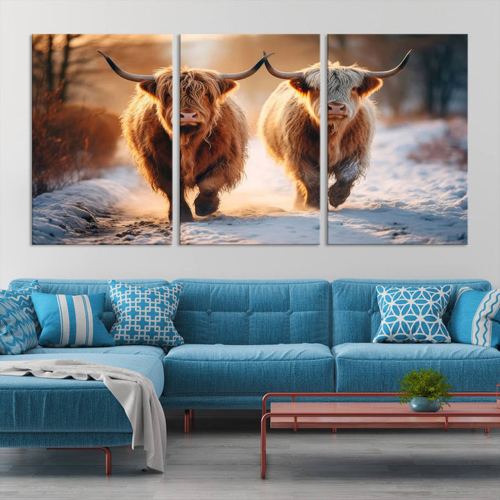 The living room showcases a triptych from the Scottish Highland Cow Horn Farm Wall Art Canvas Print collection, depicting two Highland cows running in the snow. Complementing this are handmade wall art pieces with a gallery-quality finish that add an elegant touch.