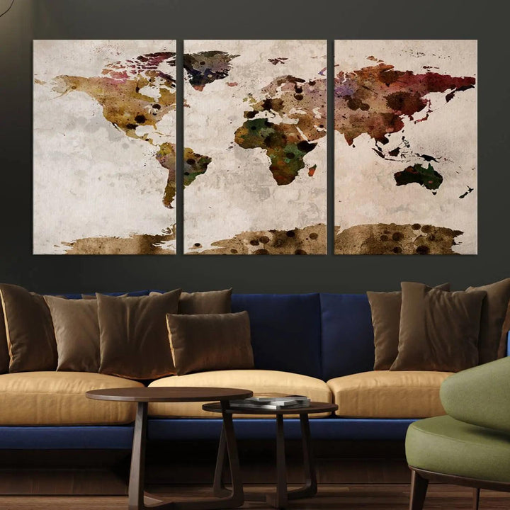 A Watercolor World Map Canvas Print, wrapped in an elegant gallery style, hangs on the wall.