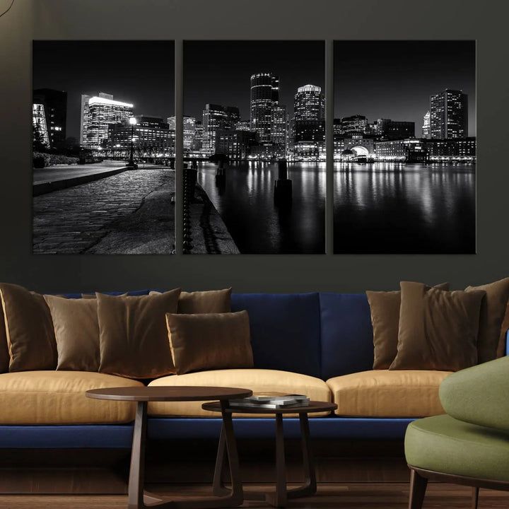 The Boston City Lights Skyline Black and White Wall Art Cityscape Canvas Print portrays a triptych of the city skyline at night reflecting on a calm river. This museum-quality canvas features UV-protective finishes to preserve its timeless allure.