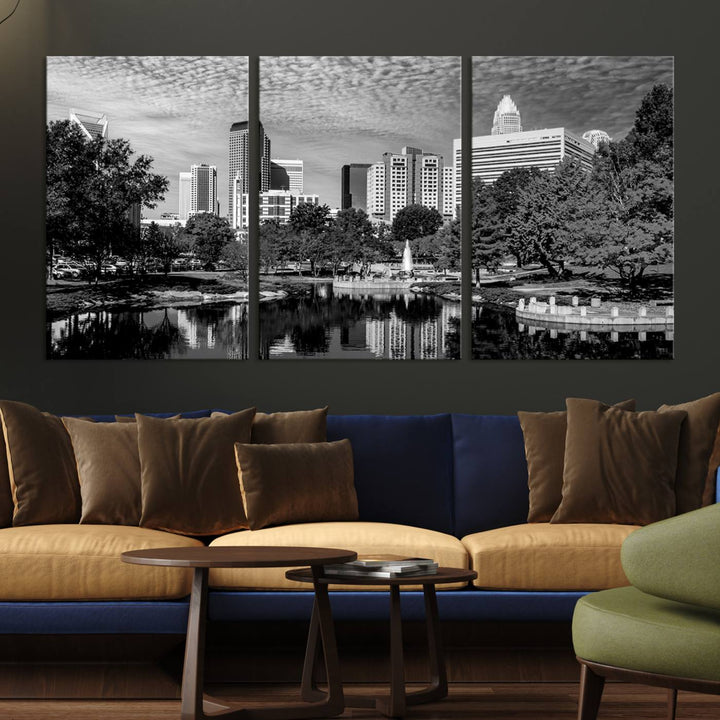 The living room features a captivating triptych titled "Charlotte City Cloudy Skyline Black and White Wall Art Cityscape Canvas Print," crafted on museum-quality canvas with UV-protective coating. Modern decor accentuates the dynamic scene.