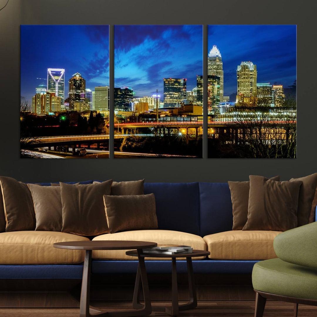 A modern living room highlighted by the "Charlotte City Lights Cloudy Blue Night Skyline Cityscape View" wall art canvas print, crafted on museum-quality canvas with UV-protective coating.