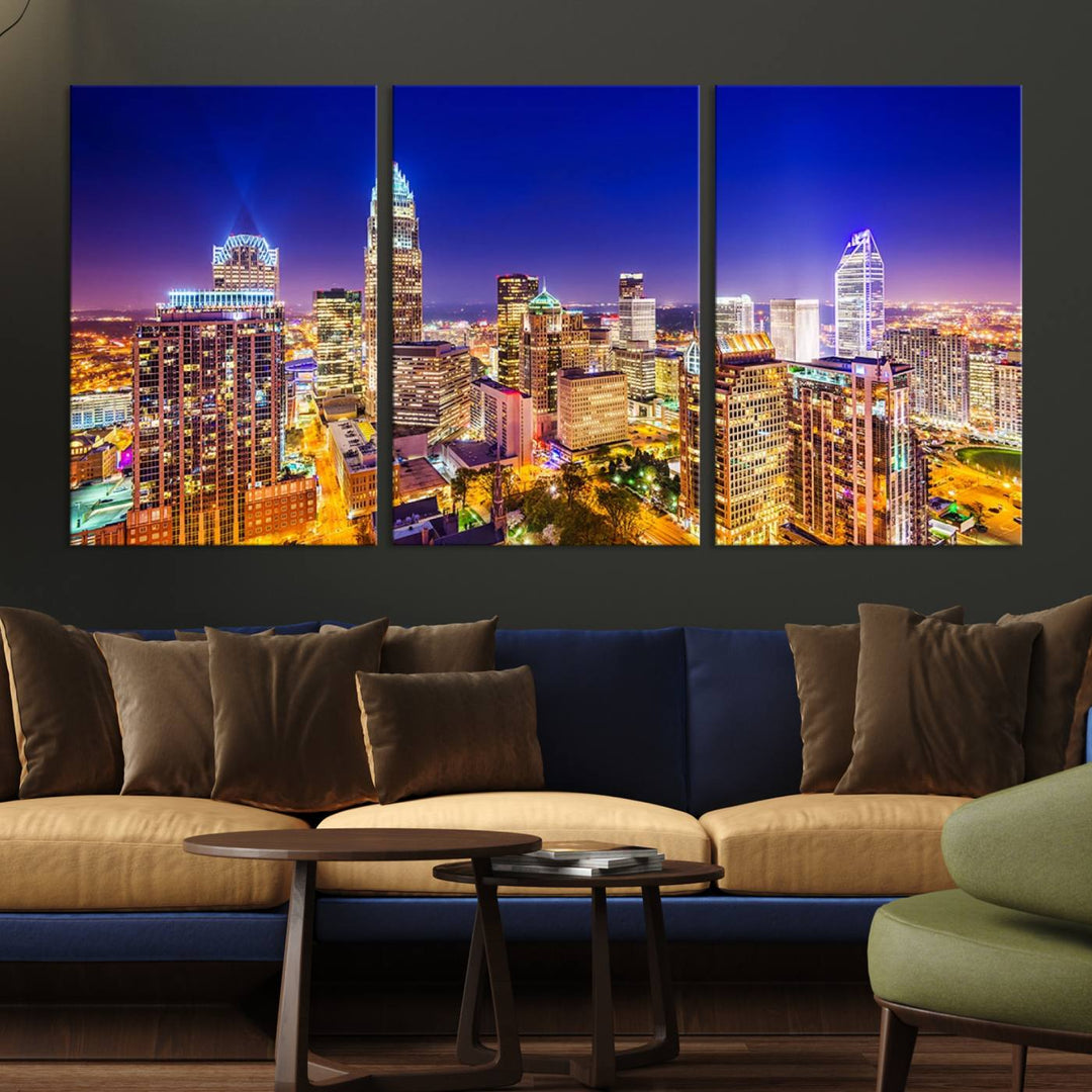 A modern living room features the Charlotte City Lights Night Blue Skyline Cityscape View wall art canvas print.