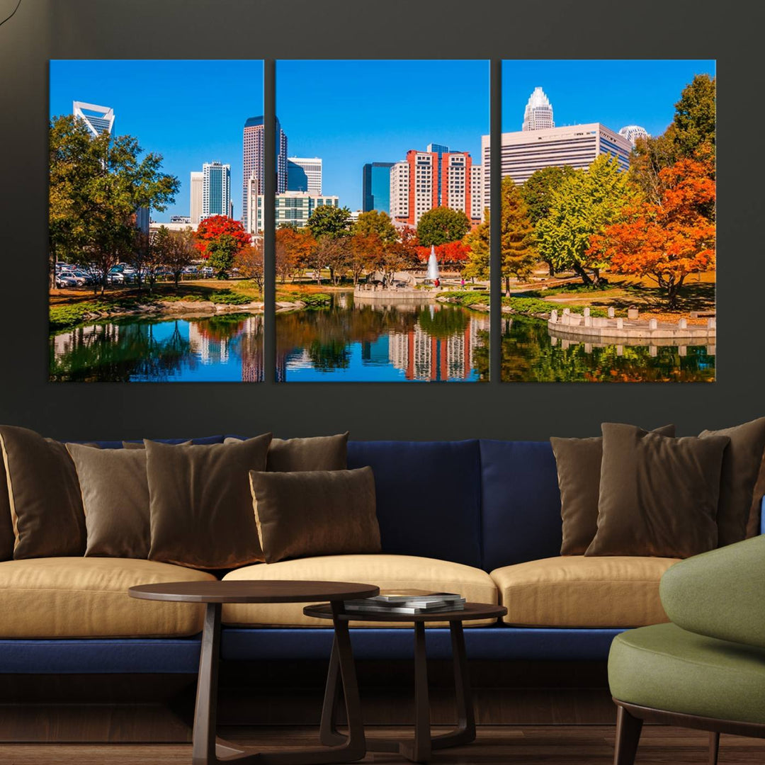 The Charlotte City Park at Fall Skyline Cityscape View wall art canvas print features a city panorama with a park and lake accented by autumn trees. It is mounted on museum-quality canvas with UV-protective coating and decorates the space.