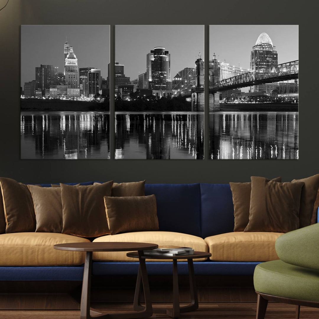 The wall showcases a ready-to-hang triptych of the Cincinnati City Lights Skyline in black and white, printed on museum-quality canvas.