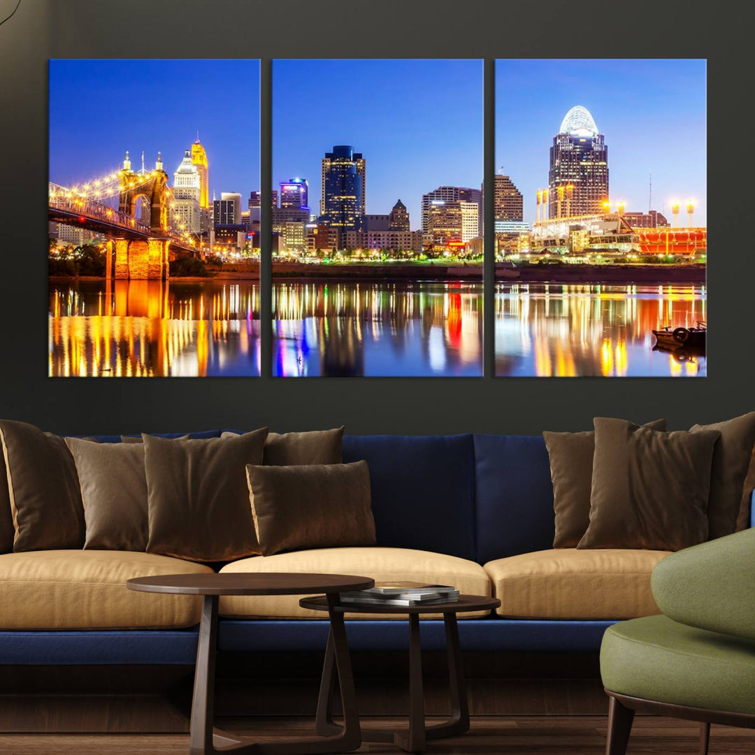 The "Cincinnati City Lights Night Skyline Cityscape View Wall Art Canvas Print" is a gallery-wrapped, museum-quality canvas illustrating a lit-up bridge and skyline at night. Enhanced with a UV-protective coating, this piece ensures lasting vibrancy.