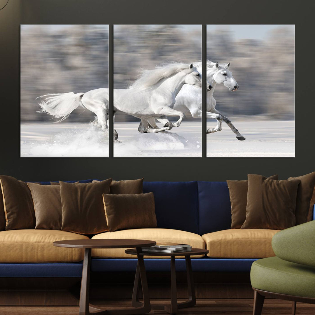 The "All The White Horses Wall Art Canvas Print" depicts a triptych of galloping white horses across a snowy landscape. These museum-quality canvases come with a UV-protective coating to maintain their stunning appearance over time.