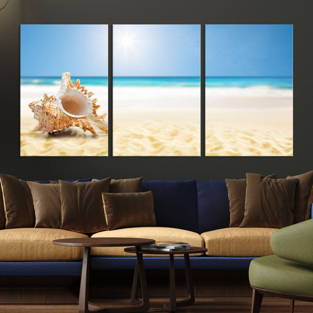 The Sea Shell on The Beach Sun Sand Wall Art Canvas Print is a triptych that beautifully captures a beach scene with a large seashell on the sand.