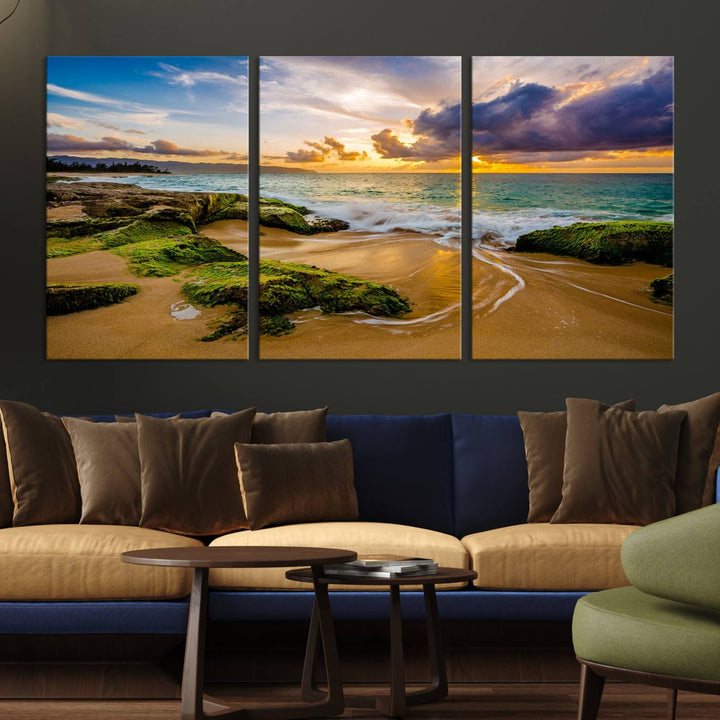 The Sunset Beach Wall Art Canvas Print is a gallery-wrapped triptych showcasing a beach scene with mossy rocks and a vibrant sunset. Made from museum-quality canvas and featuring a UV-protective coating, it elegantly provides both beauty and durability.