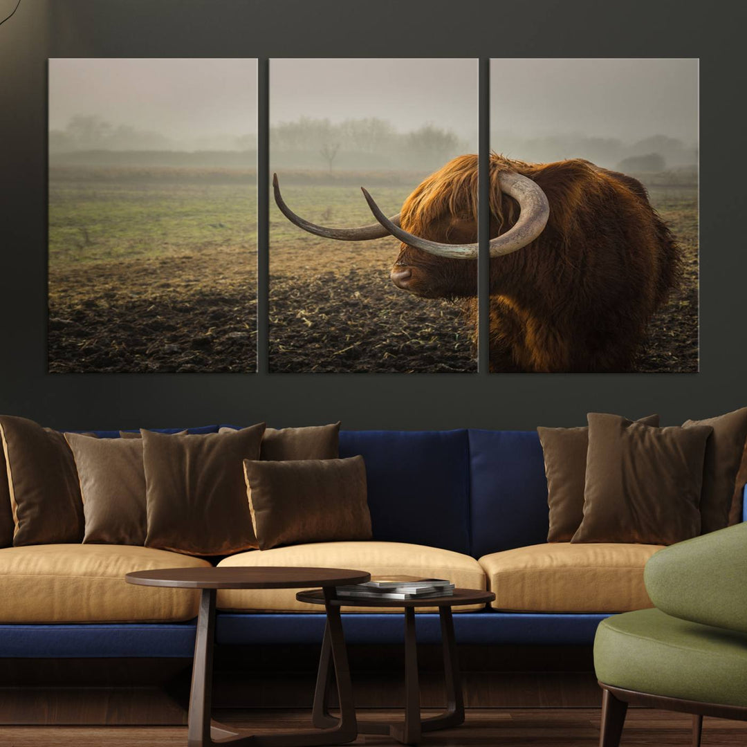 The "Big Cow Horn Wall Art Canvas Print" is a hand-assembled framed canvas depicting a Highland cow in a misty field. It is crafted with a UV-protective coating to ensure lasting vibrancy.