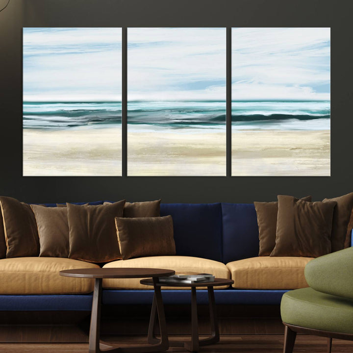 The room features the Ocean Abstract Wall Art Canvas Print, a triptych beach painting on museum-quality canvas with a gallery-wrapped finish and UV-protective coating.