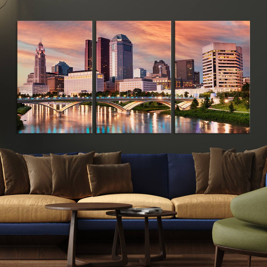 The "Columbus City Lights Sunset Orange Cloudy Skyline Cityscape View" wall art is featured on the wall. This triptych is printed on museum-quality canvas and includes a UV-protective coating, ensuring lasting vibrancy.