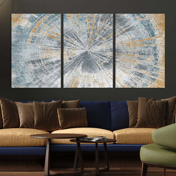 The Radiant Abstract Wood Rings Canvas Art, a modern triptych wall decor, enhances the contemporary style of the living room with its blue, white, and gold hues.