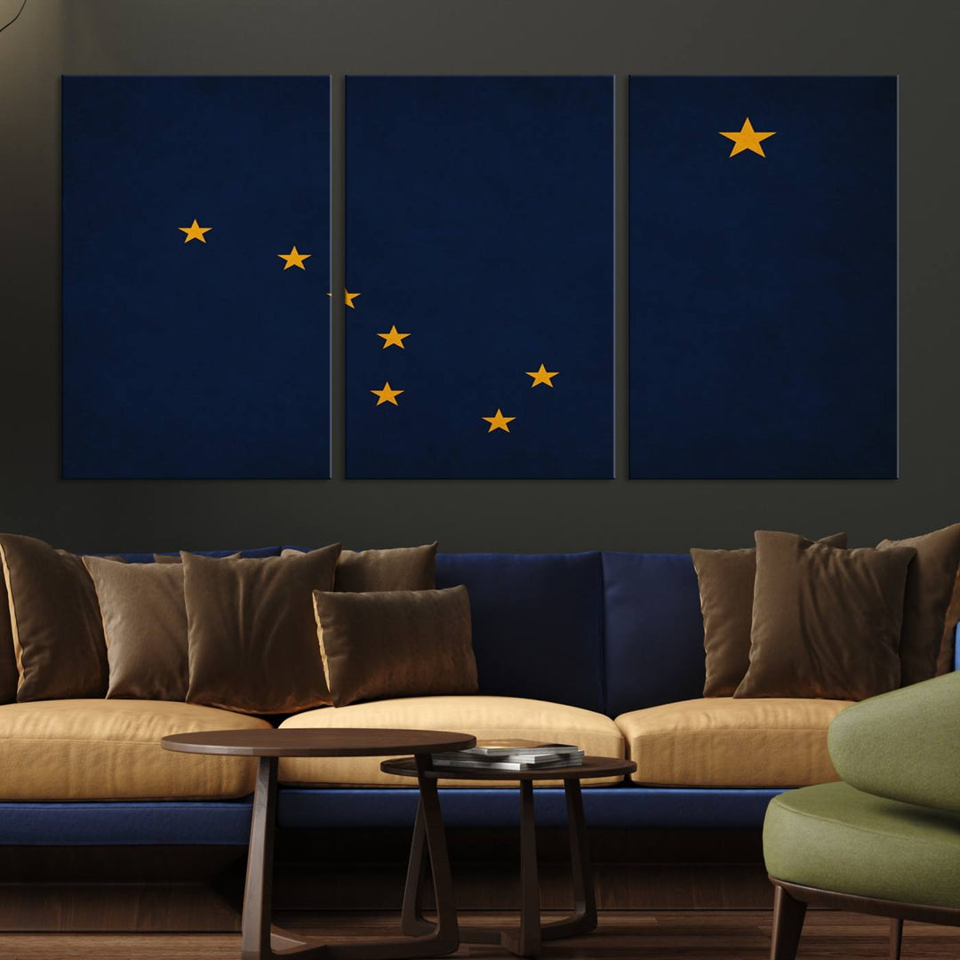 A contemporary living room featuring a triptych artwork of stars on a navy background, accentuated by the striking Alaska States Flag Wall Art Canvas Print.