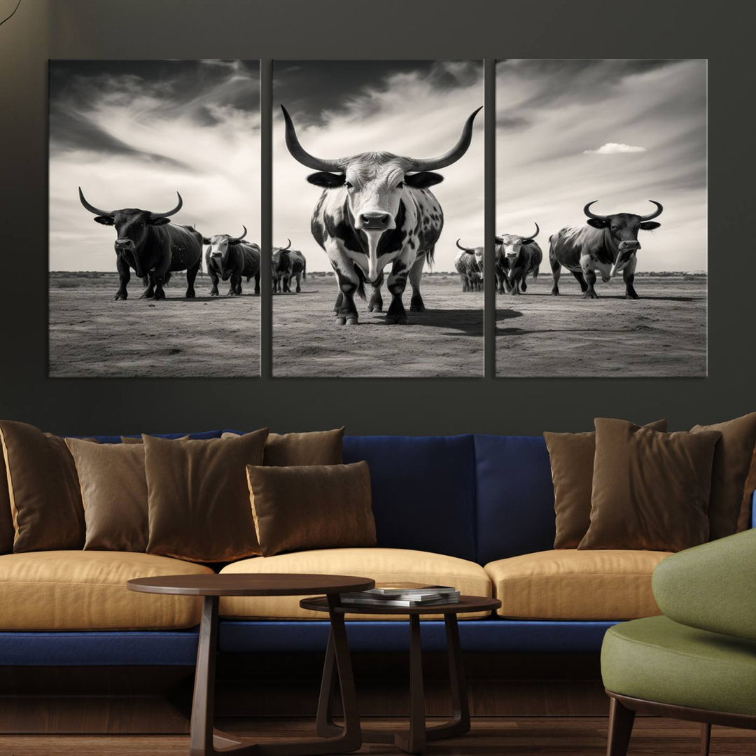 The Black and White Longhorn Cattle Wall Art, featuring a three-panel display of cowboy Western longhorns walking toward the viewer, enhances your space with its striking presence, adding a touch of Western decor.