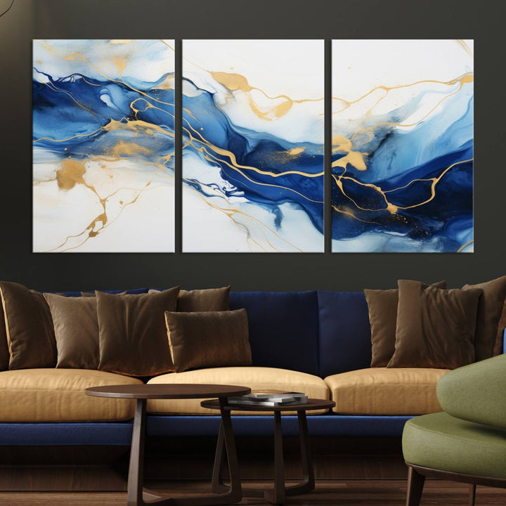 The Blue Abstract Wall Art is displayed as a triptych on museum-quality canvas, showcasing a blue and gold abstract design. The artwork includes a UV-protective coating to maintain its vibrancy and comes with the benefit of free shipping.