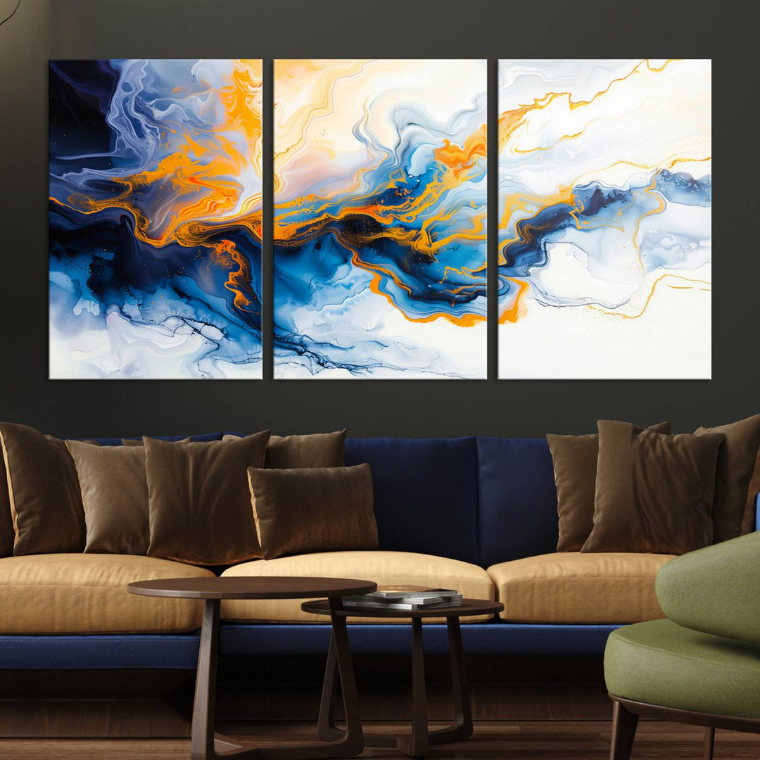 A stunning Fluid Alcohol Ink Wall Art with Gold Wall Art Canvas Print, featuring vibrant blue, orange, and white swirls, adorns the wall. This gallery-quality finish adds an exquisite touch to any living space.