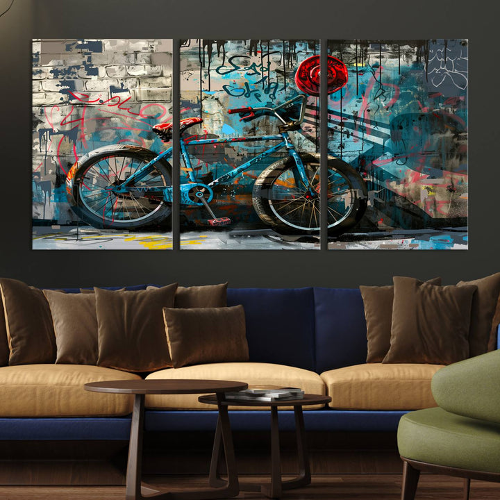 A modern living room features a triptych wall art of an abstract bicycle, designed in a graffiti style on a brick wall. This piece is expertly crafted on the Abstract Bicycle Wall Art Canvas Print, offering a premium canvas that ensures a gallery-quality finish.