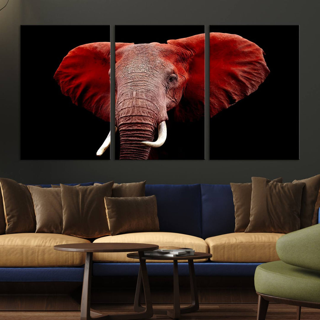 A Wall Art Canvas Print in the modern living room features a three-panel premium design of a red elephant face.