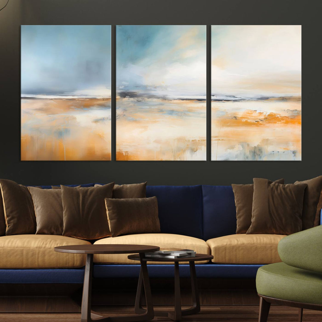 The Abstract Landscape Wall Art Canvas Print, featuring warm tones of orange and blue, is displayed on a dark wall.