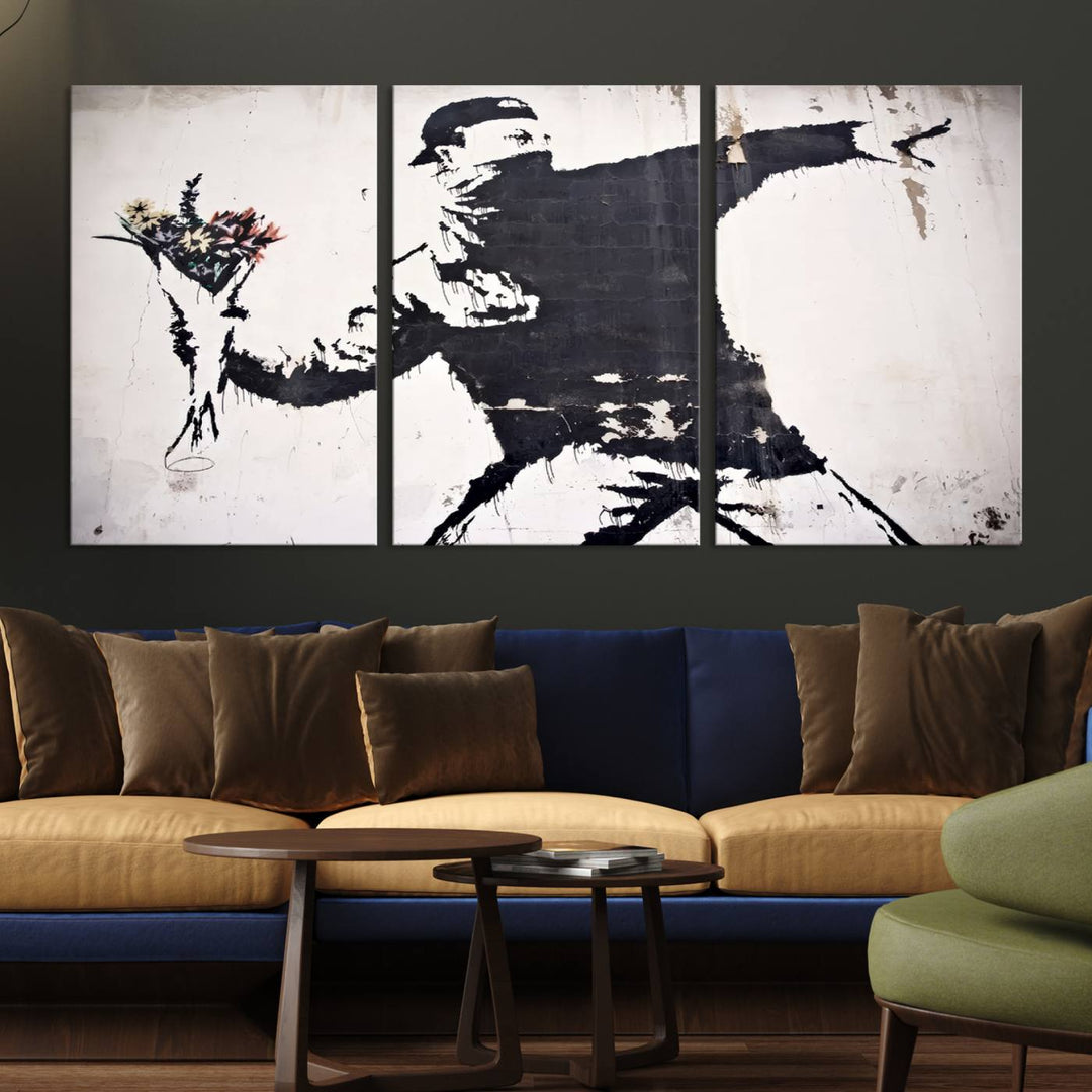 The living room features a split-panel art piece named "Banksy Flower Throw Graffiti Street Wall Art Canvas Print," gallery wrapped on museum-quality polycotton canvas and accentuated by modern decor elements.