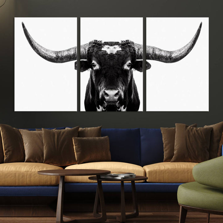 The living room is adorned with the Texas Cow Longhorn Wall Art Canvas Print in Black and White—framed and ready to hang.