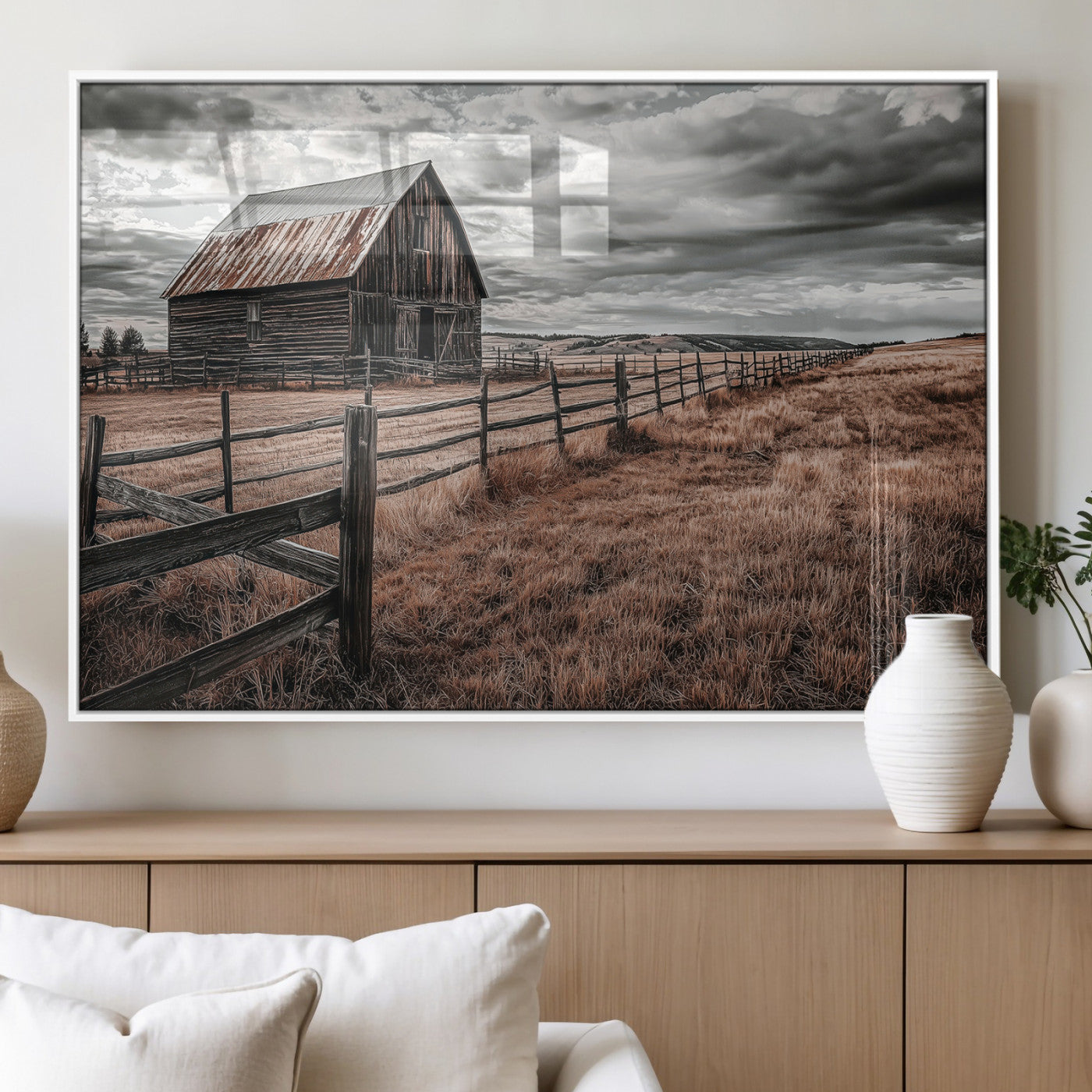 Framed canvas of a rustic barn under a moody sky with weathered fence and dark fields, ideal for farmhouse or rural-style wall decor.