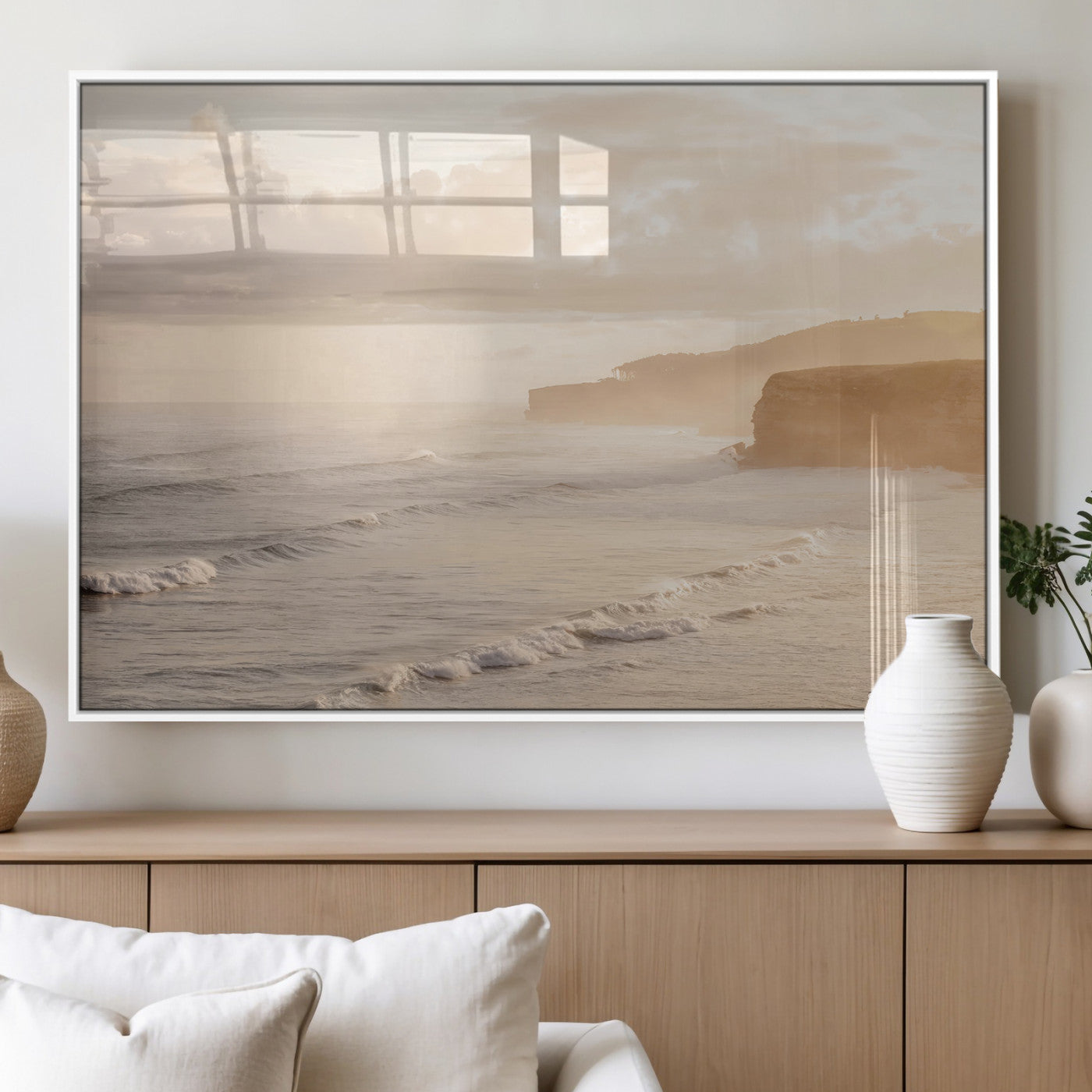 Golden hour seascape with misty cliffs and gentle waves rolling towards the shore, capturing a tranquil and warm coastal atmosphere.