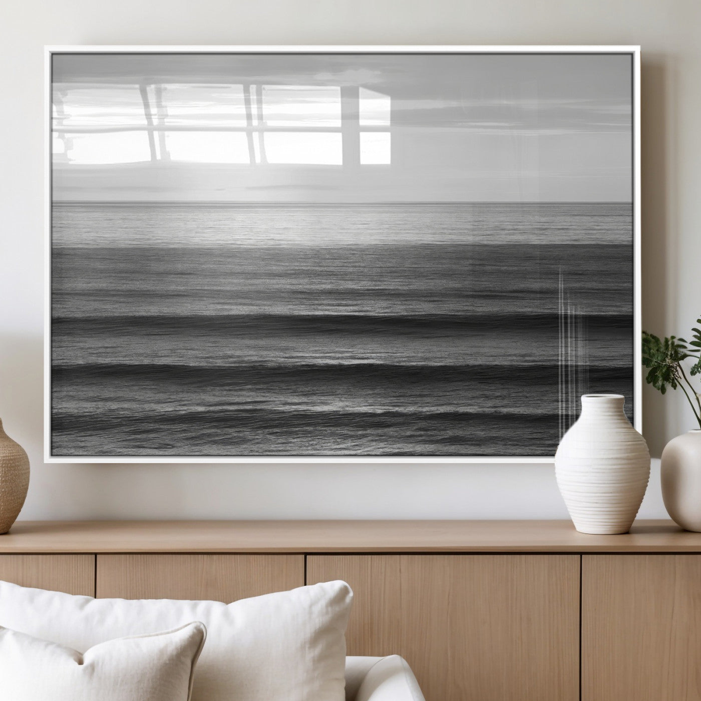 Minimalist black and white ocean view with layered waves reflecting sunlight, evoking a sense of calm and coastal serenity.