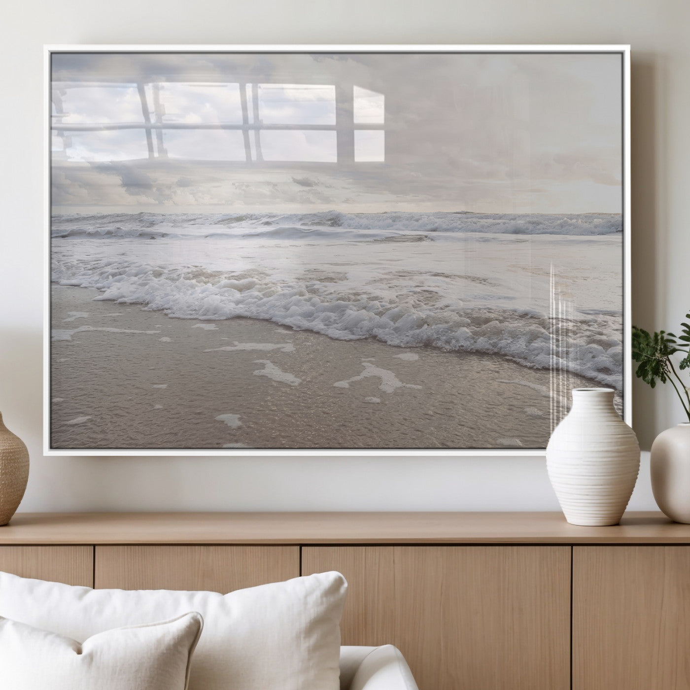 Peaceful ocean waves rolling onto the sandy shore under soft light, perfect for neutral or coastal minimalist decor themes.