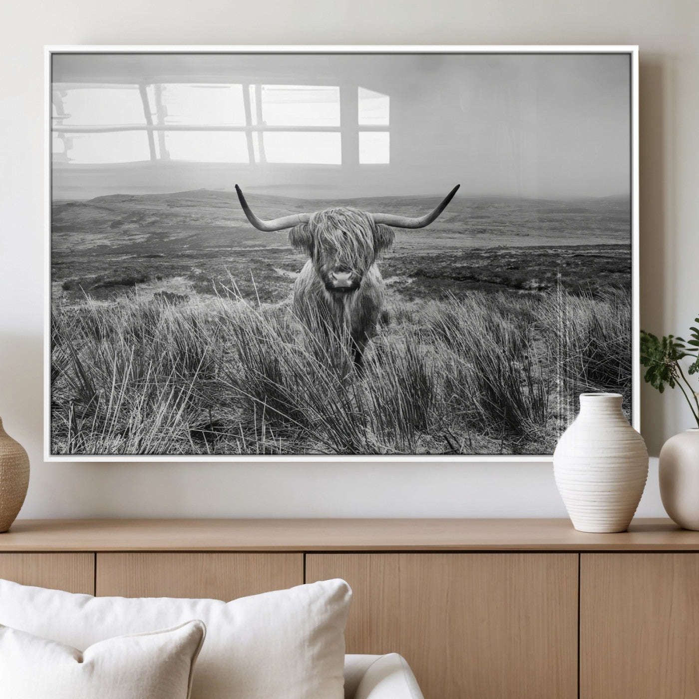 A black and white portrait of a Highland cow in a foggy Scottish countryside, capturing a rustic aesthetic and tranquil farm escape.