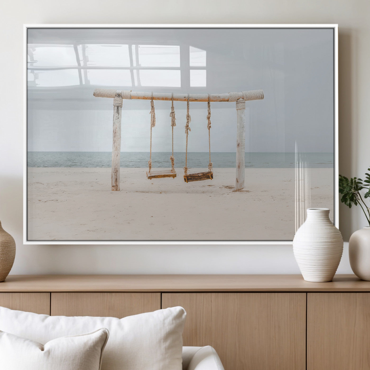 A rustic wooden beach swing stands on a serene sandy shore with an ocean horizon in the background, creating a tranquil and dreamy coastal escape.