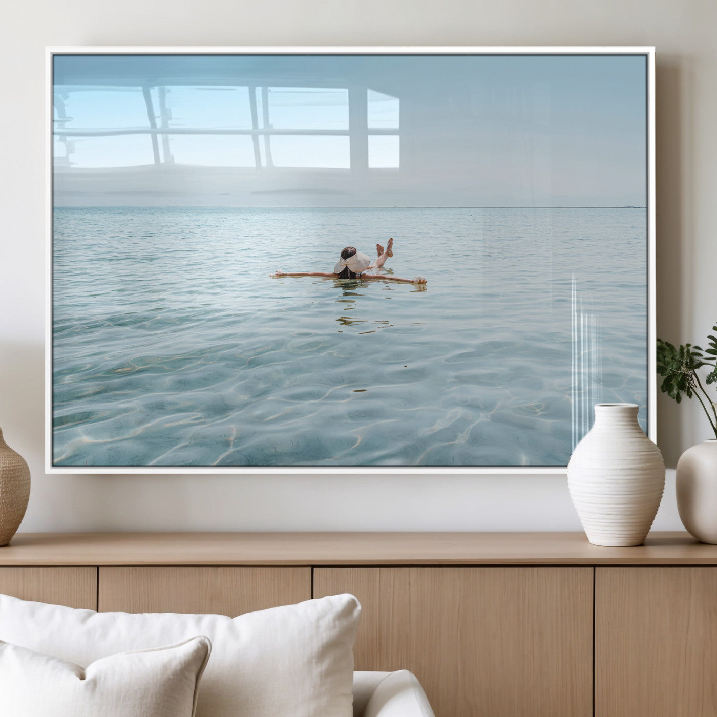 A peaceful minimalist scene of a person floating on crystal-clear water, surrounded by a vast open horizon, capturing relaxation and serenity in a tranquil aquatic setting.
