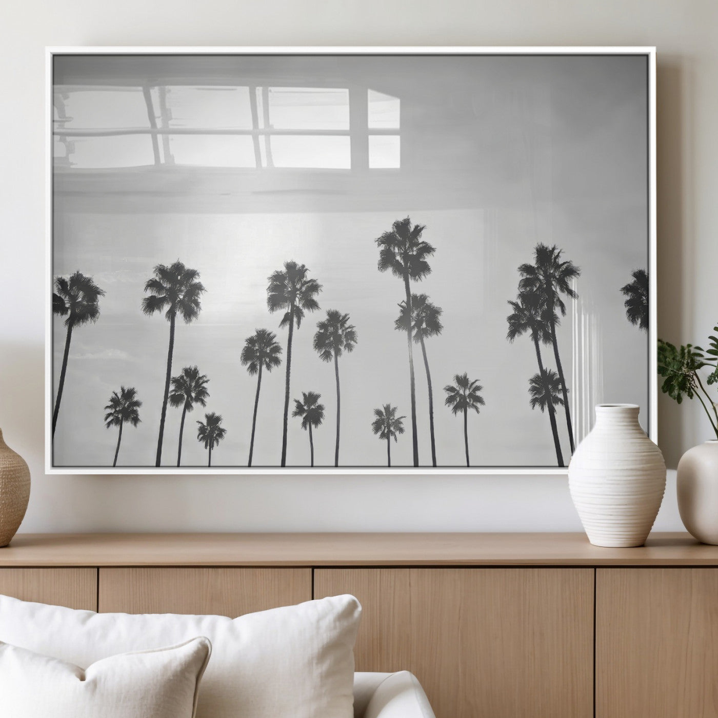 A black and white minimalist scene featuring tall palm trees silhouetted against a bright sky, creating a dreamy and timeless tropical aesthetic.