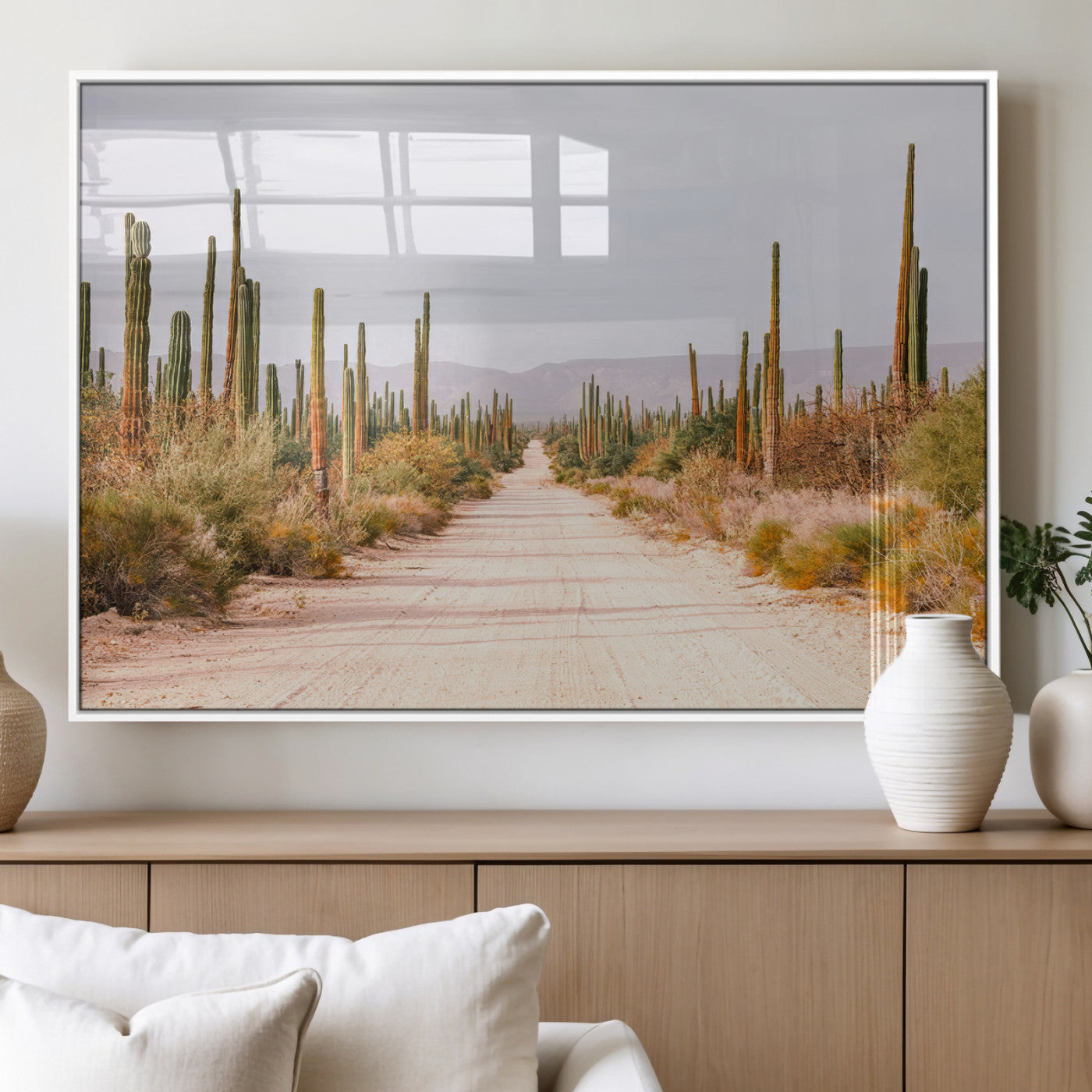 A desert road lined with saguaro cacti under a golden sky, creating a warm southwestern feel, perfect for boho or rustic decor.
