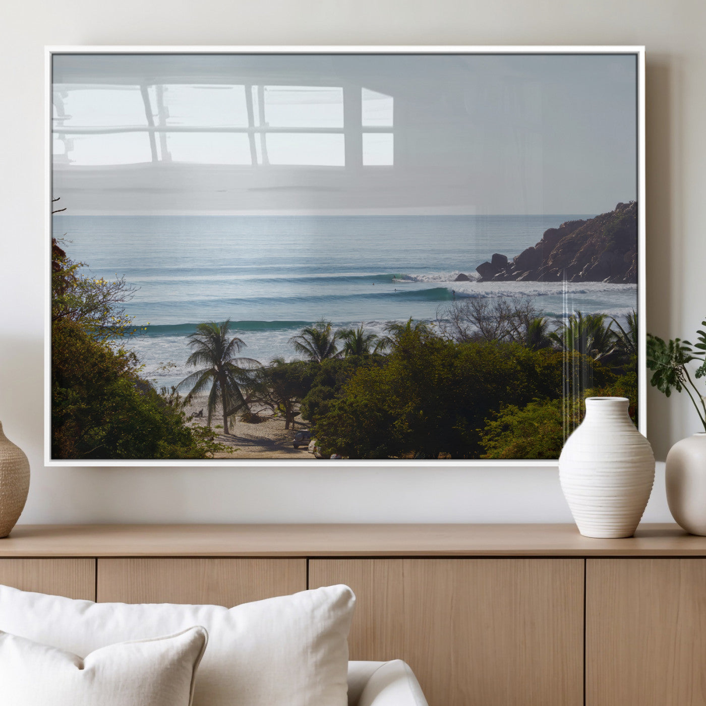 View of calm ocean waves with palm trees and a tropical coastline, ideal for coastal boho or beach-themed wall decor.