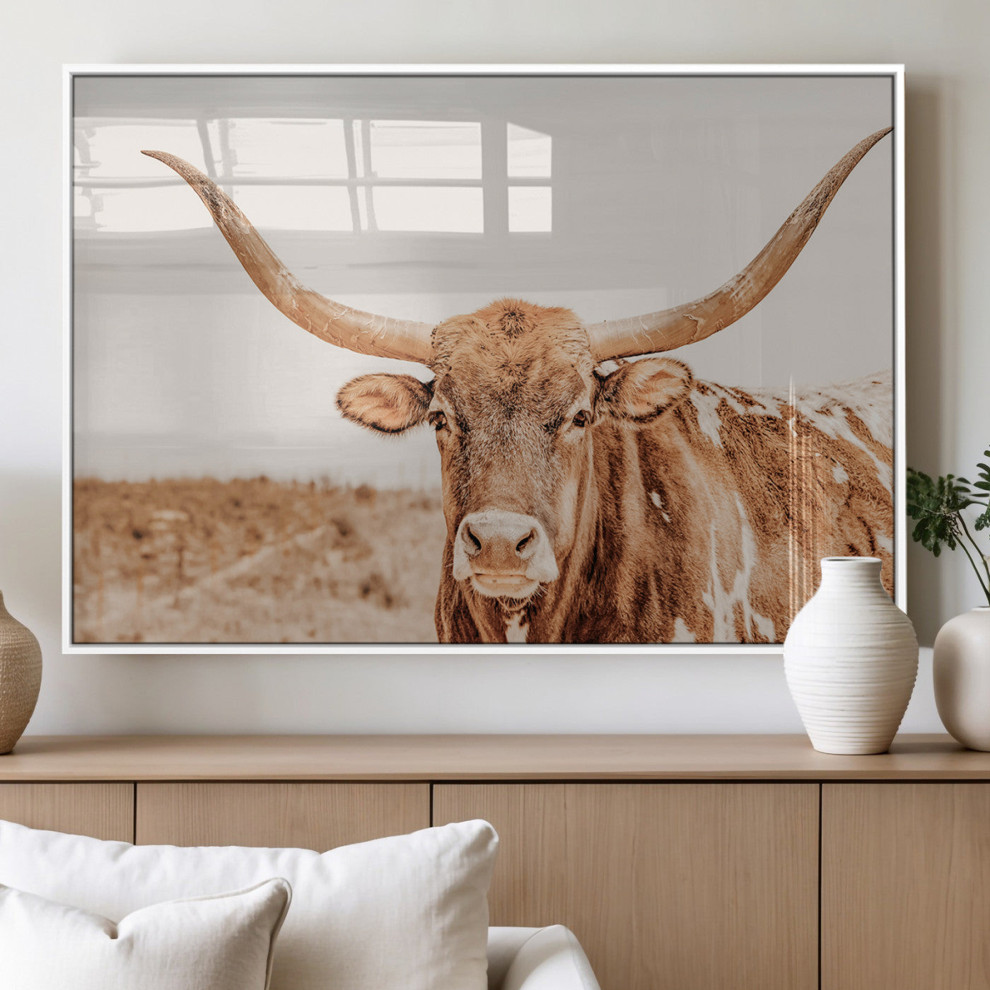 Sepia-toned Texas Longhorn facing forward in a dry field, perfect for rustic farmhouse or western-themed neutral home decor.