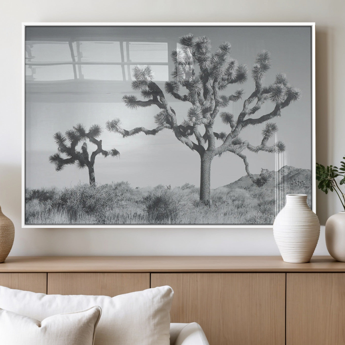 Two Joshua trees in a black and white desert landscape with distant hills, ideal for boho or rustic interior wall styling.