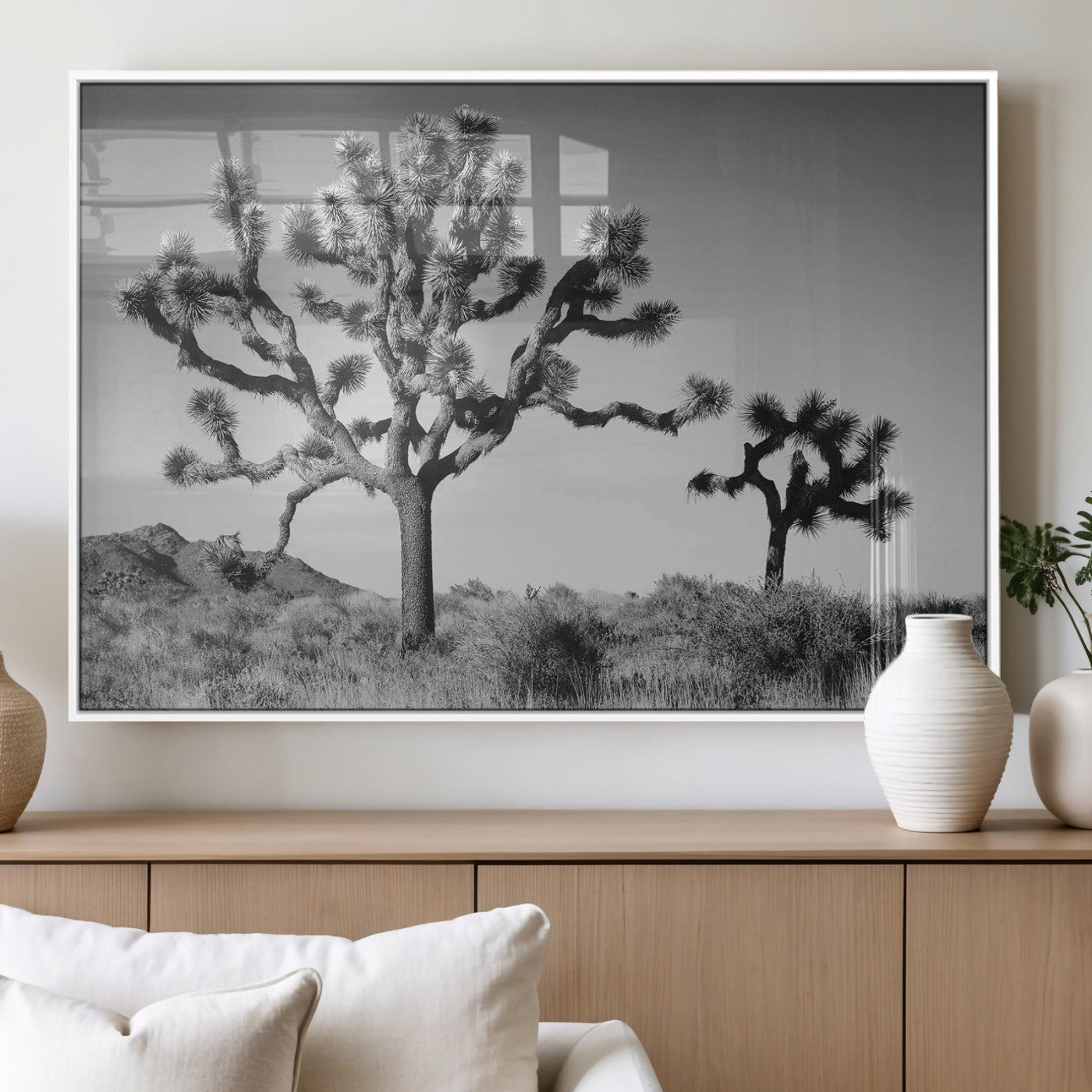 Black and white desert scene with two Joshua trees under clear sky, perfect for rustic or boho-inspired home decor.
