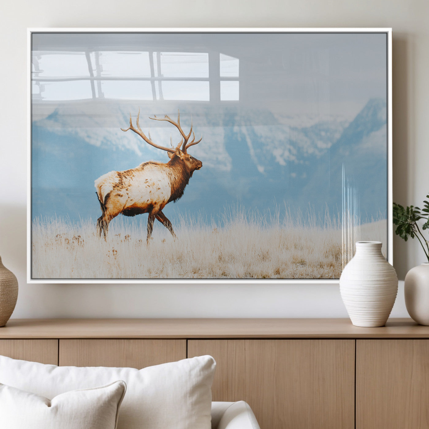 Majestic elk standing on dry grassland with snowy mountains in the background, ideal for rustic or lodge-inspired wall decor.