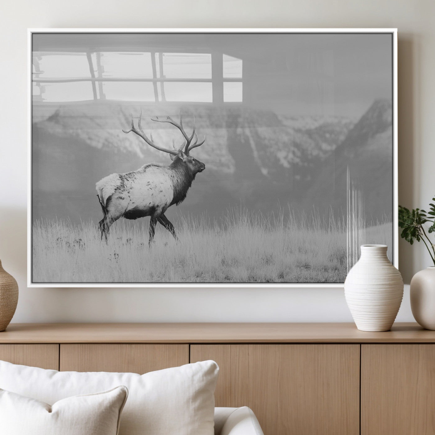 Black and white elk standing in front of snowy mountain range, perfect for rustic lodge or nature-inspired wall decor.
