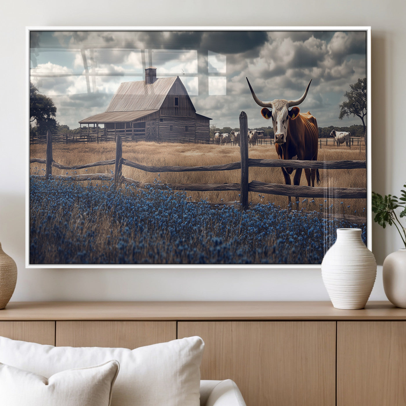 Framed canvas art of a Texas Longhorn cow near a rustic barn and bluebonnet field, ideal for country-style or farmhouse wall decor.