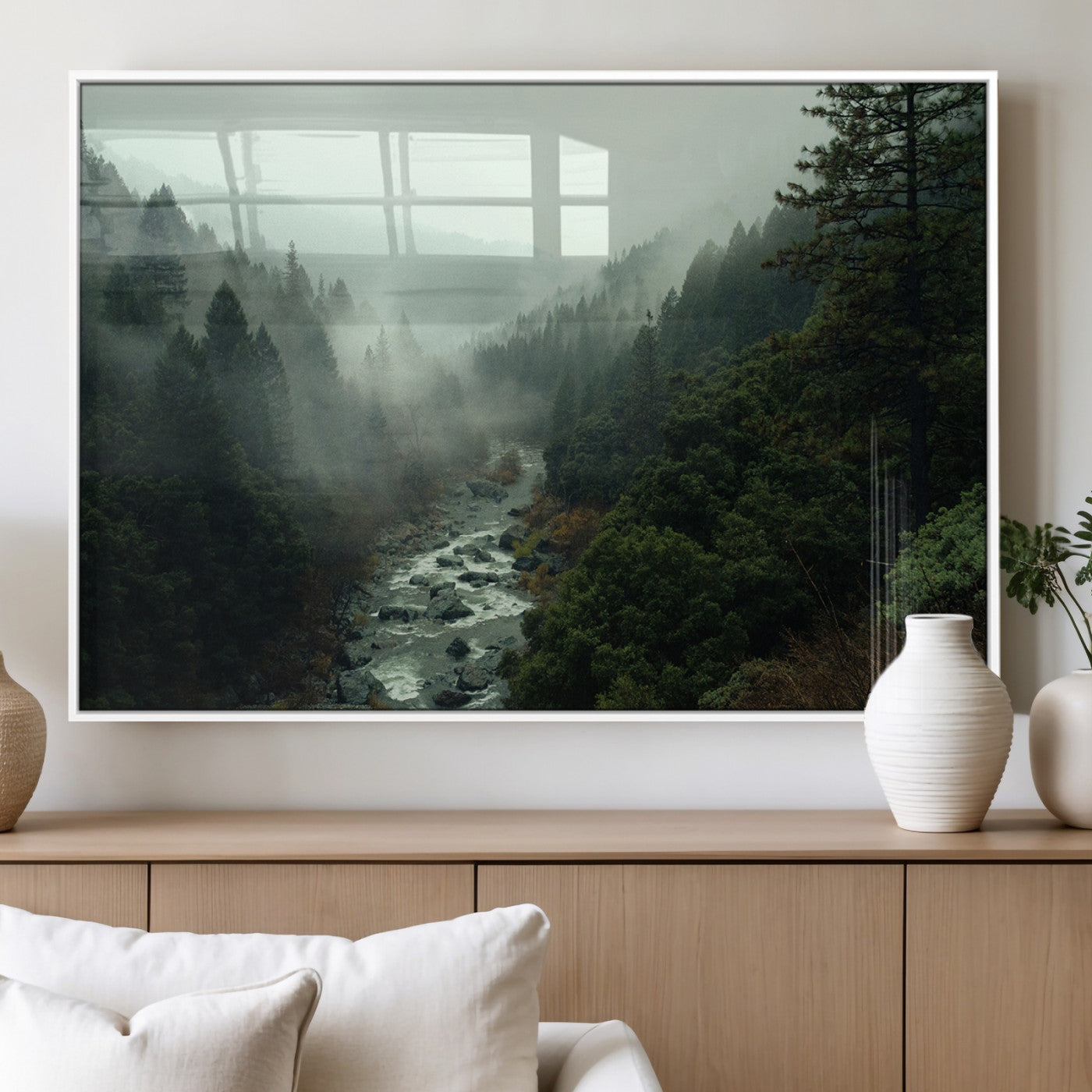 Misty forest with a winding river flowing through lush green mountains, creating a tranquil and moody wilderness landscape.