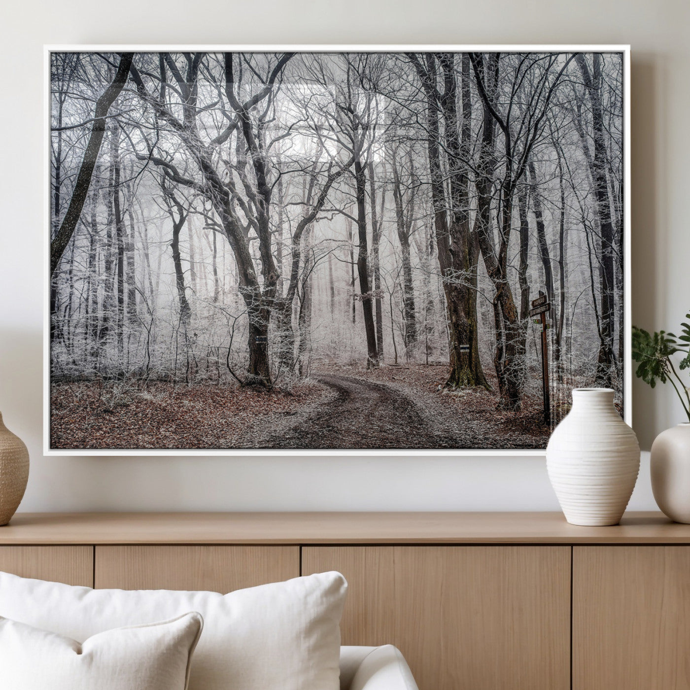 Snow-covered trees in a misty winter forest with a winding path, creating a serene and mysterious atmosphere, perfect for nature-inspired wall art.