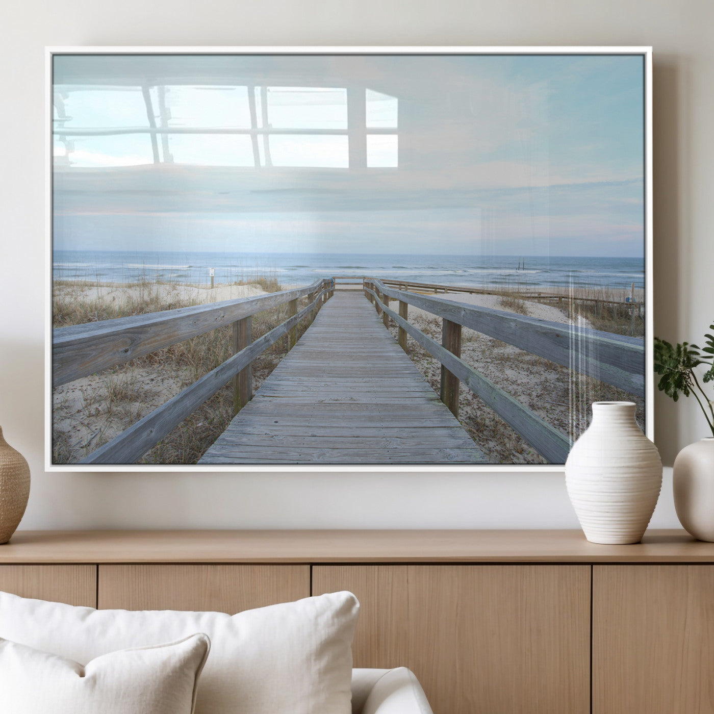 Wooden boardwalk leading to a peaceful beach with gentle ocean waves under a soft pastel sky, perfect for coastal and nautical home decor.