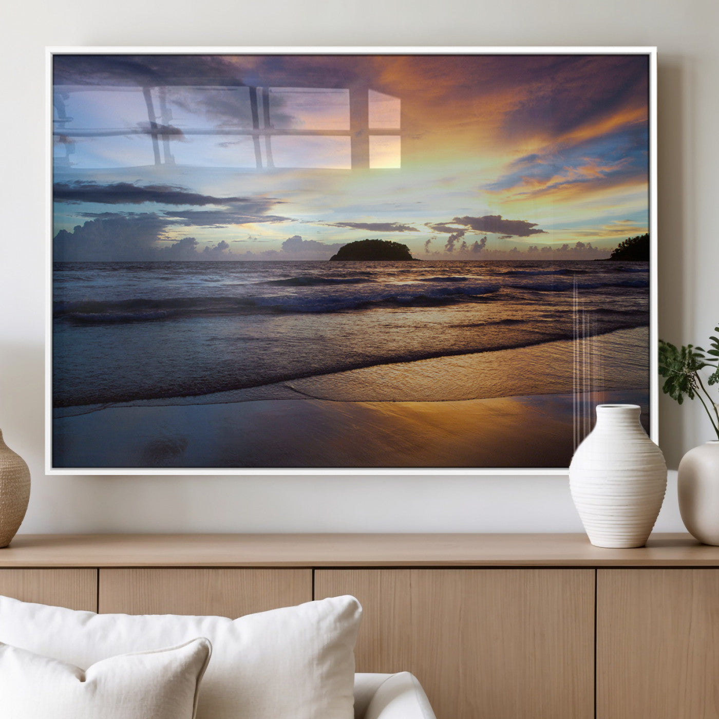A tropical beach at sunset with waves gently washing ashore, reflecting golden and purple hues in the sky, creating a tranquil coastal scene.