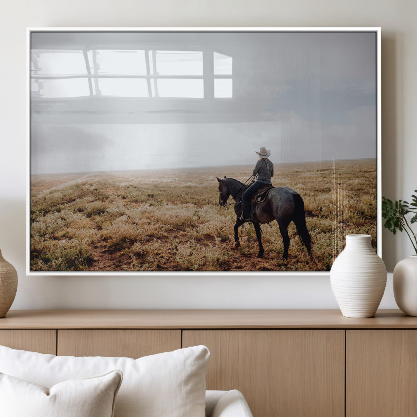 A lone cowboy riding horseback across an open prairie under a vast sky, capturing the rugged and timeless spirit of the Western frontier.