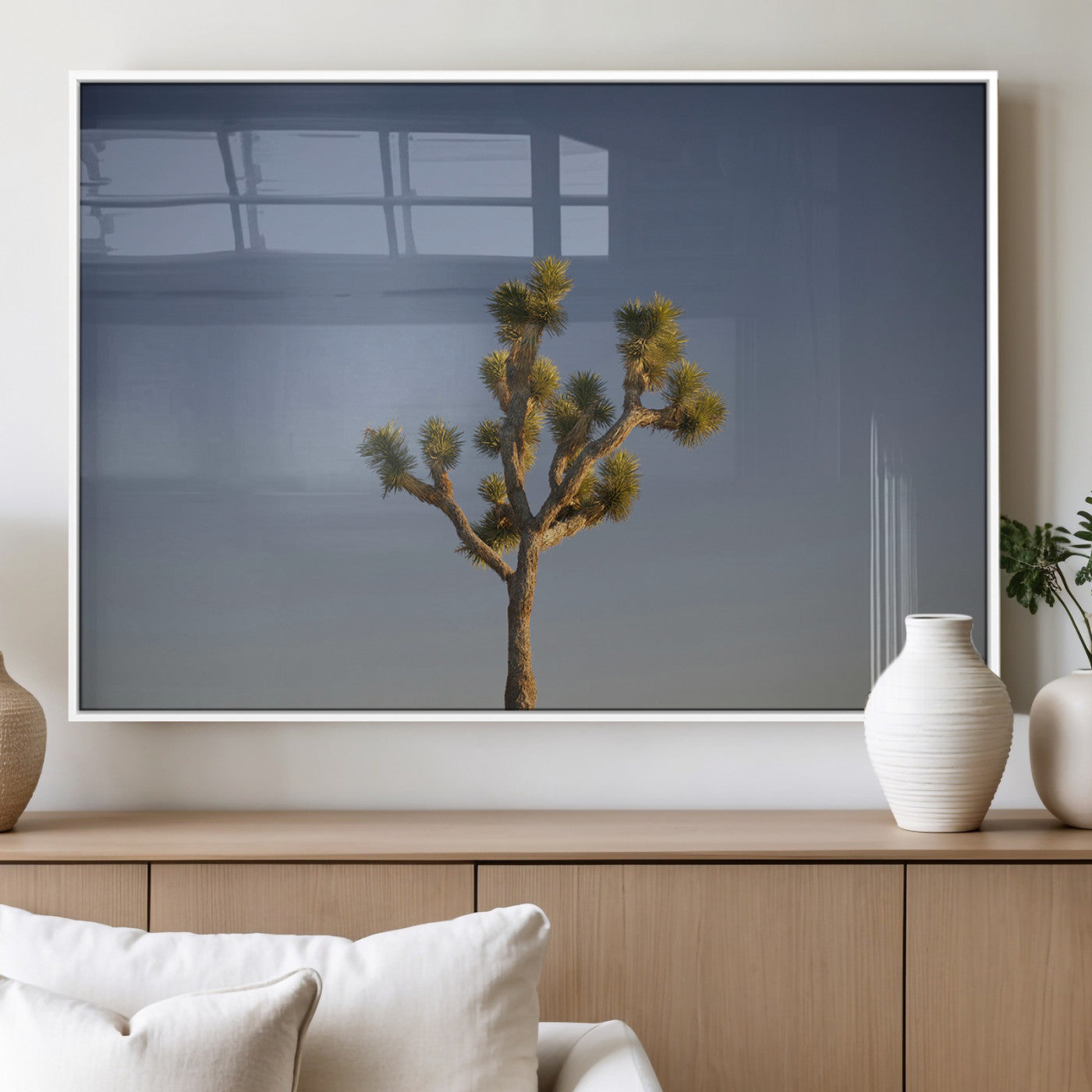 A lone Joshua Tree standing against a deep blue sky, capturing the serene and rugged beauty of the Southwestern desert landscape.