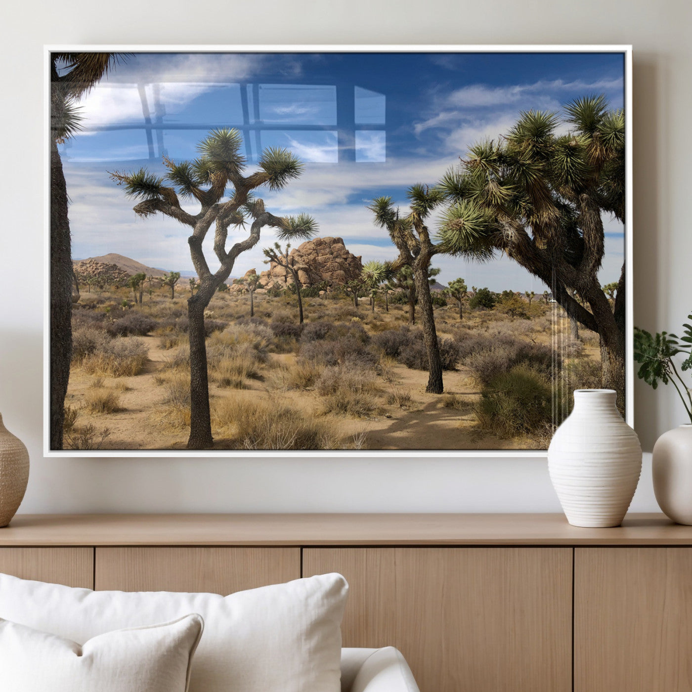 Scenic Joshua Tree landscape with rugged desert terrain, golden dry grass, and a deep blue sky, creating a warm, rustic Southwestern aesthetic.