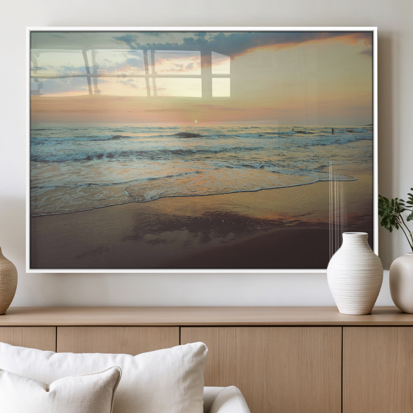 Warm sunset over gentle ocean waves with pastel sky and reflections on wet sand, creating a calm and soothing beach ambiance.