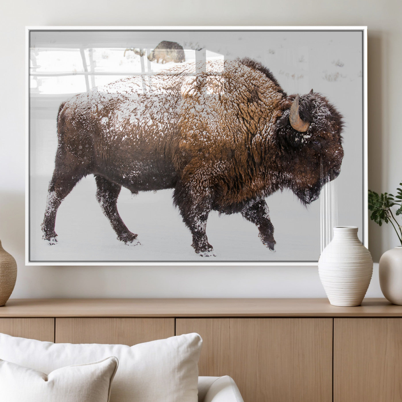Side profile of a powerful bison walking through deep snow, with frost-covered fur and a white winter background, perfect for rustic and western decor.